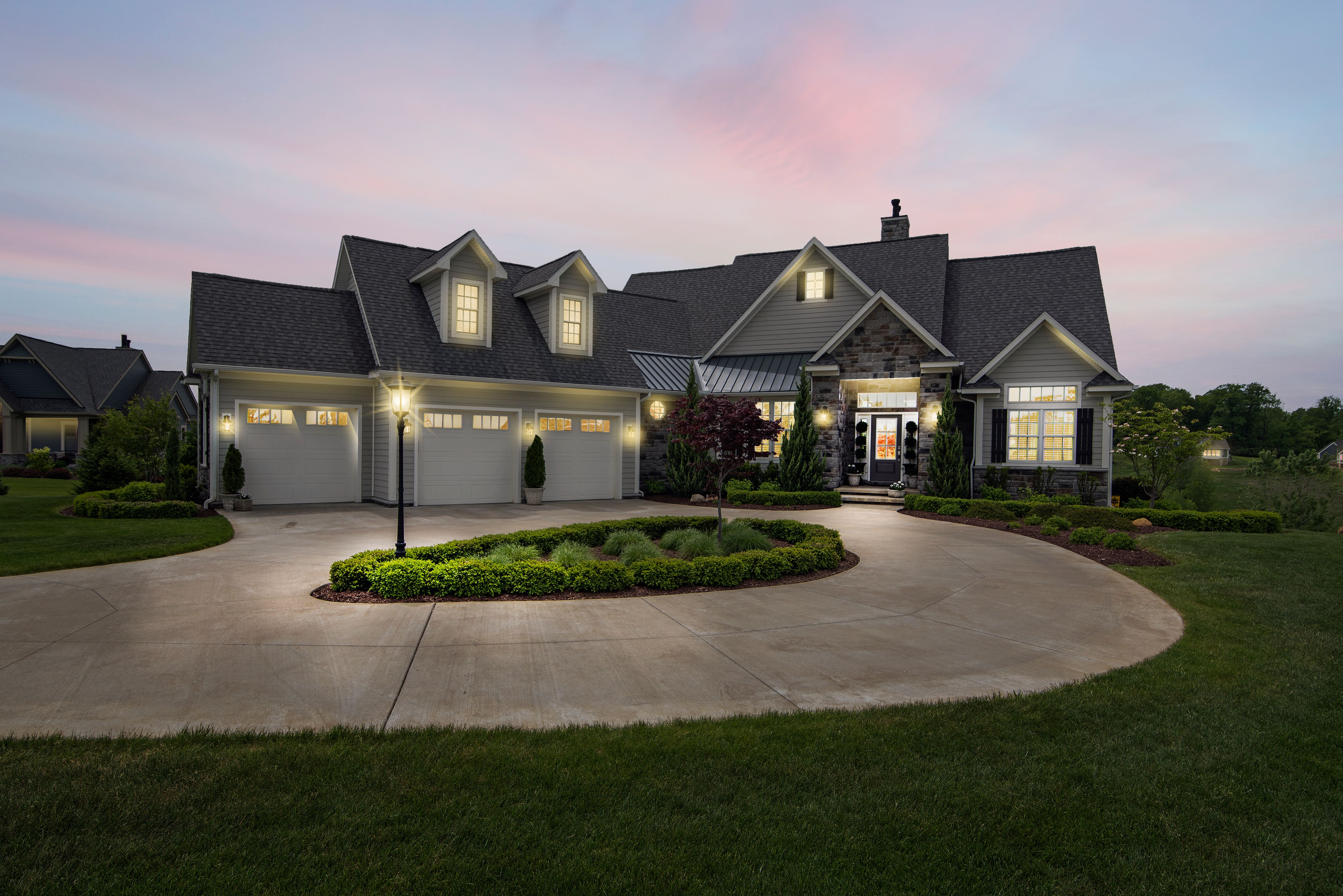 An illuminated home at dusk; illustrative stock photography